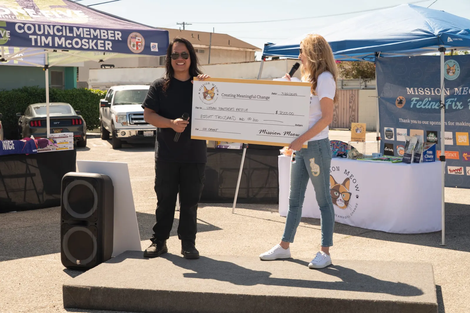 Mission Meow presents a giant $8,000 check to Urban Panthers Rescue at Feline Fix Fest