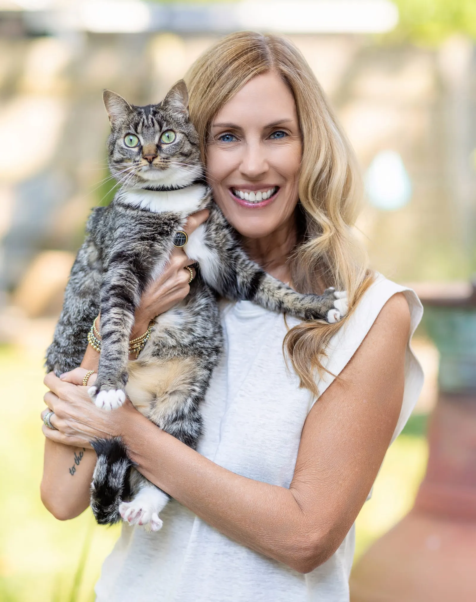 Sally Williams smiling and holding a tabby cat