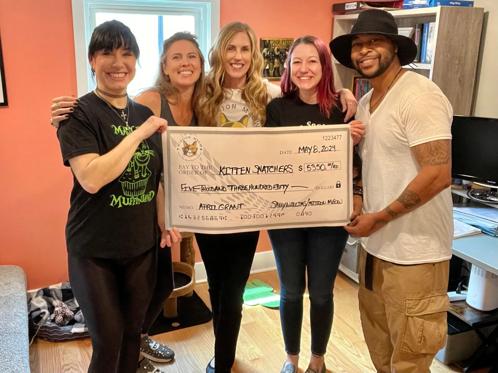 The Kitten Snatchers team holds its $5,350 Mission Meow grant check