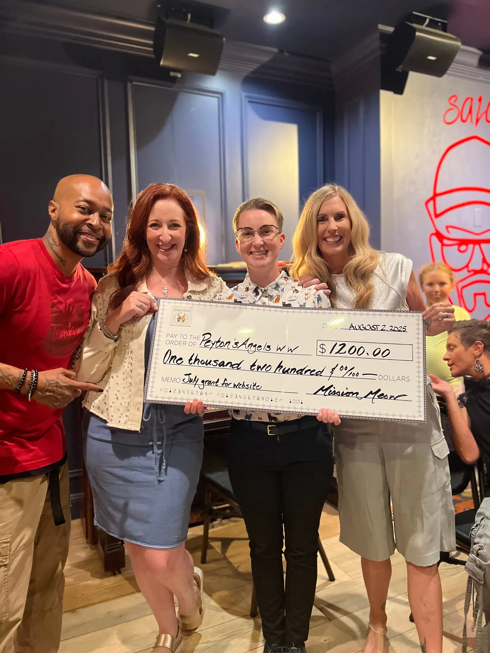 The Peyton’s Angels group with its $1,200 check