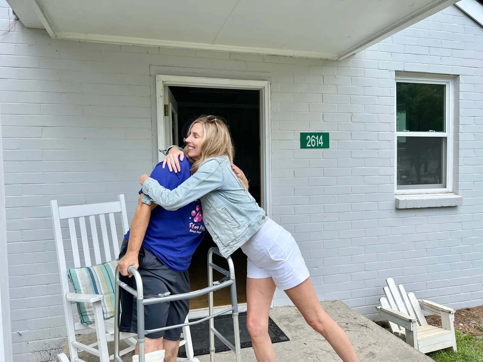 A big hug on the porch of For the Love of a Paw’s clinic