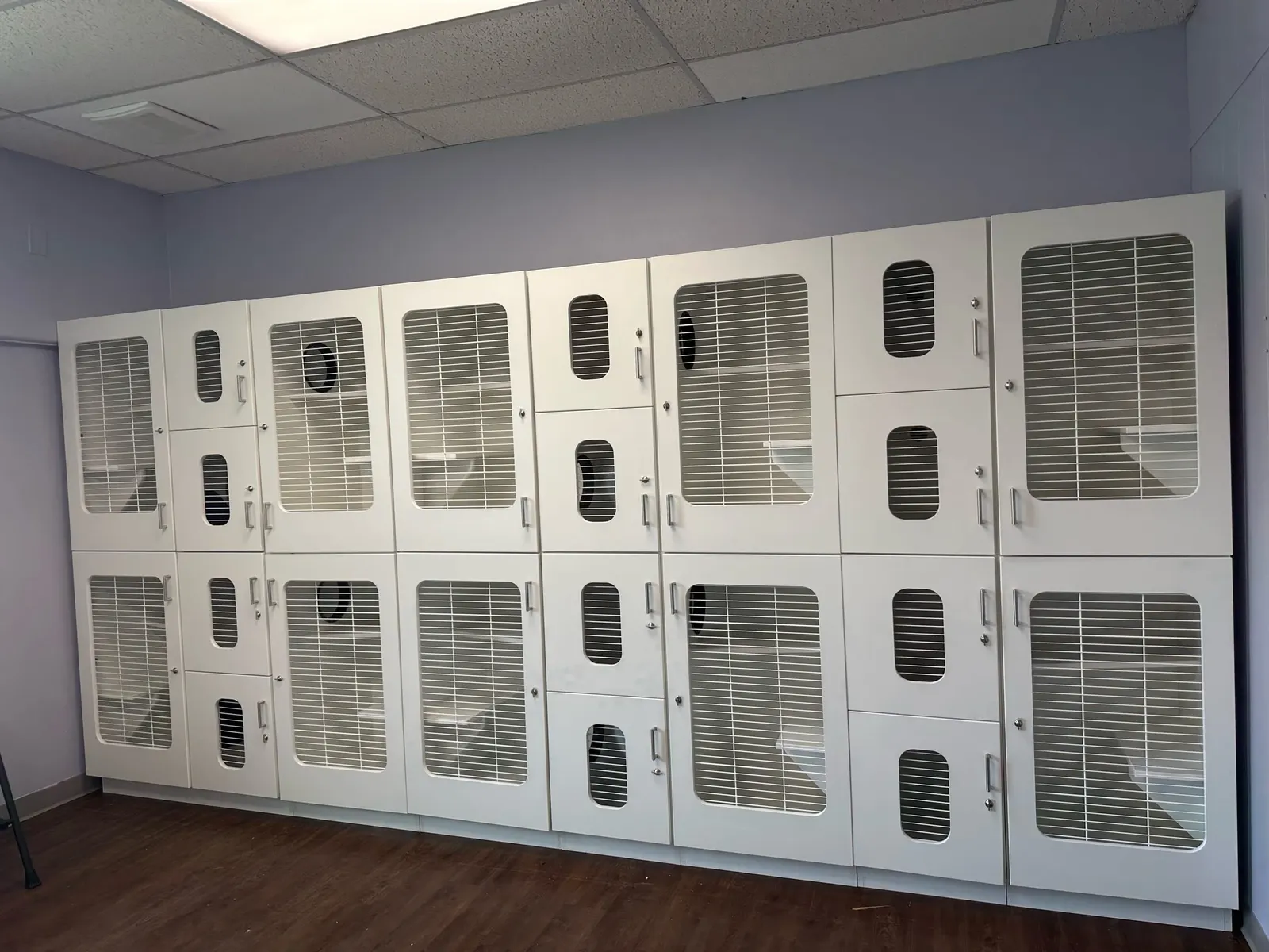 A wall of new white cat condos installed in a room